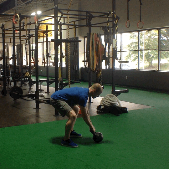 Coach Chris demonstrating proper form with the kettlebell swing at BSP NOVA in Sterling, Virginia