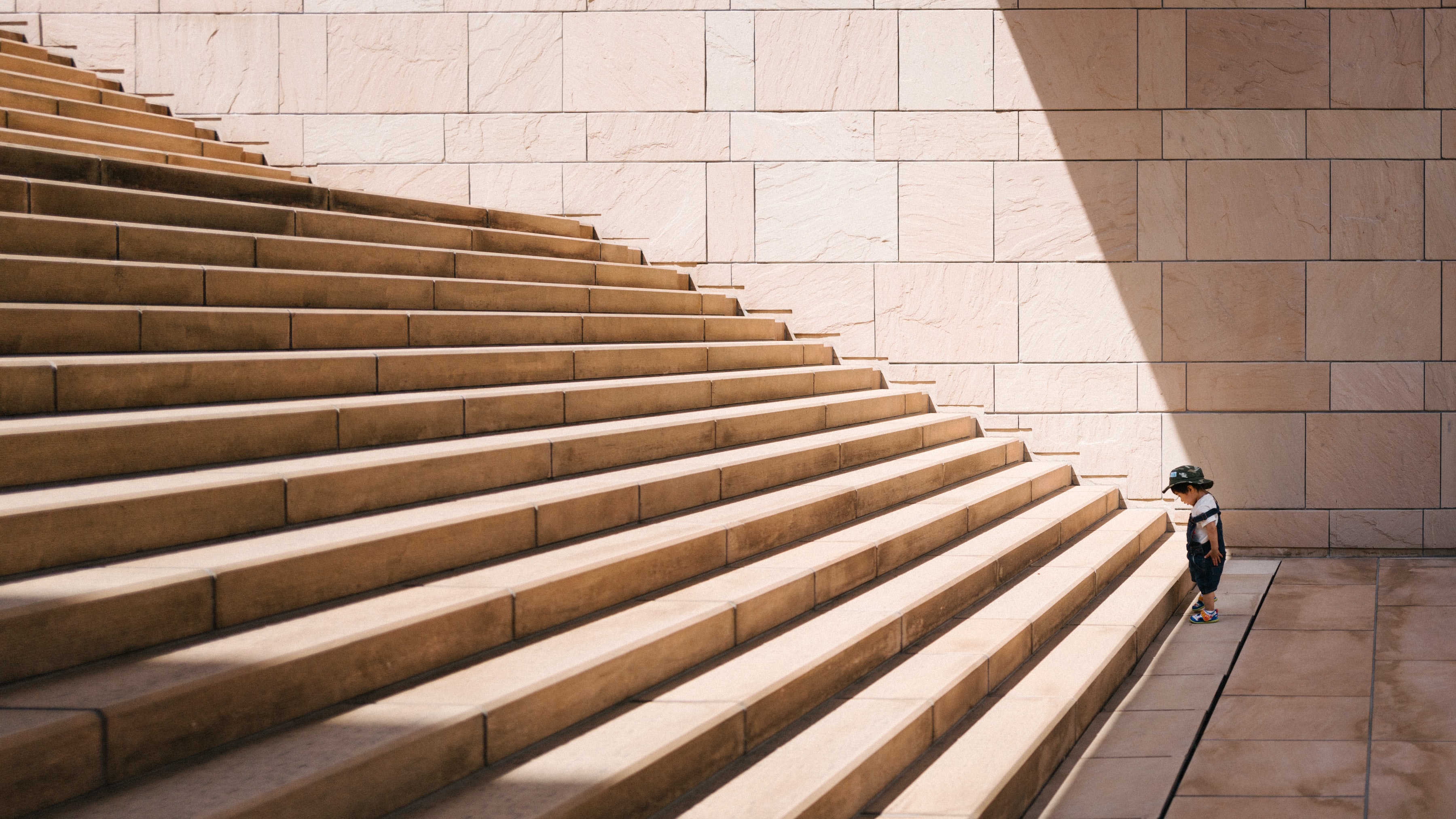 a toddler struggling to climb stairs