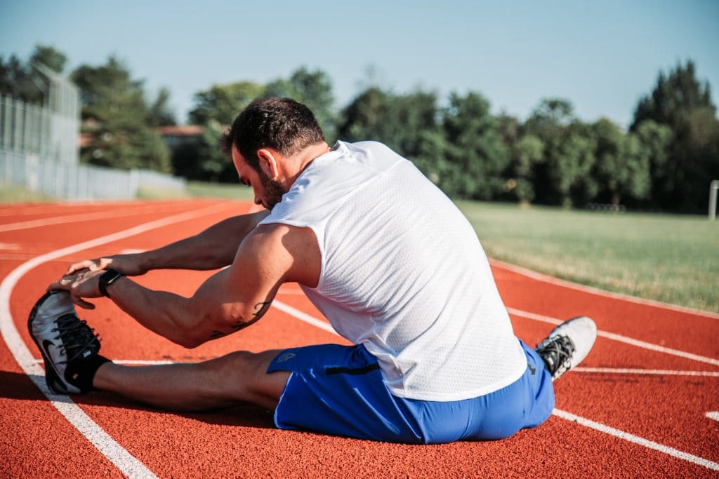 a runner performing a hamstring stretch