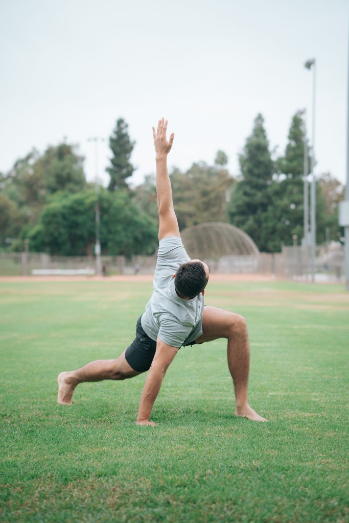 an athlete performing a dynamic stretch