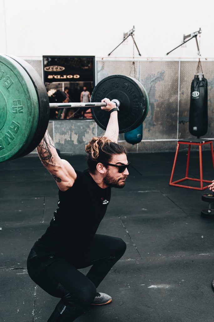 an olympic lifter performing a snatch, requiring lots of flexibility