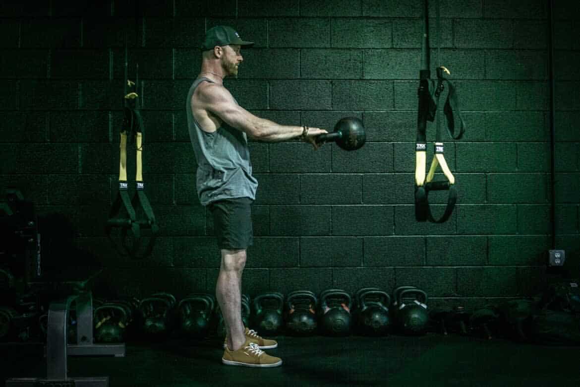 Chris Merritt doing a kettlebell swing at Beyond Strength in Sterling, Virginia