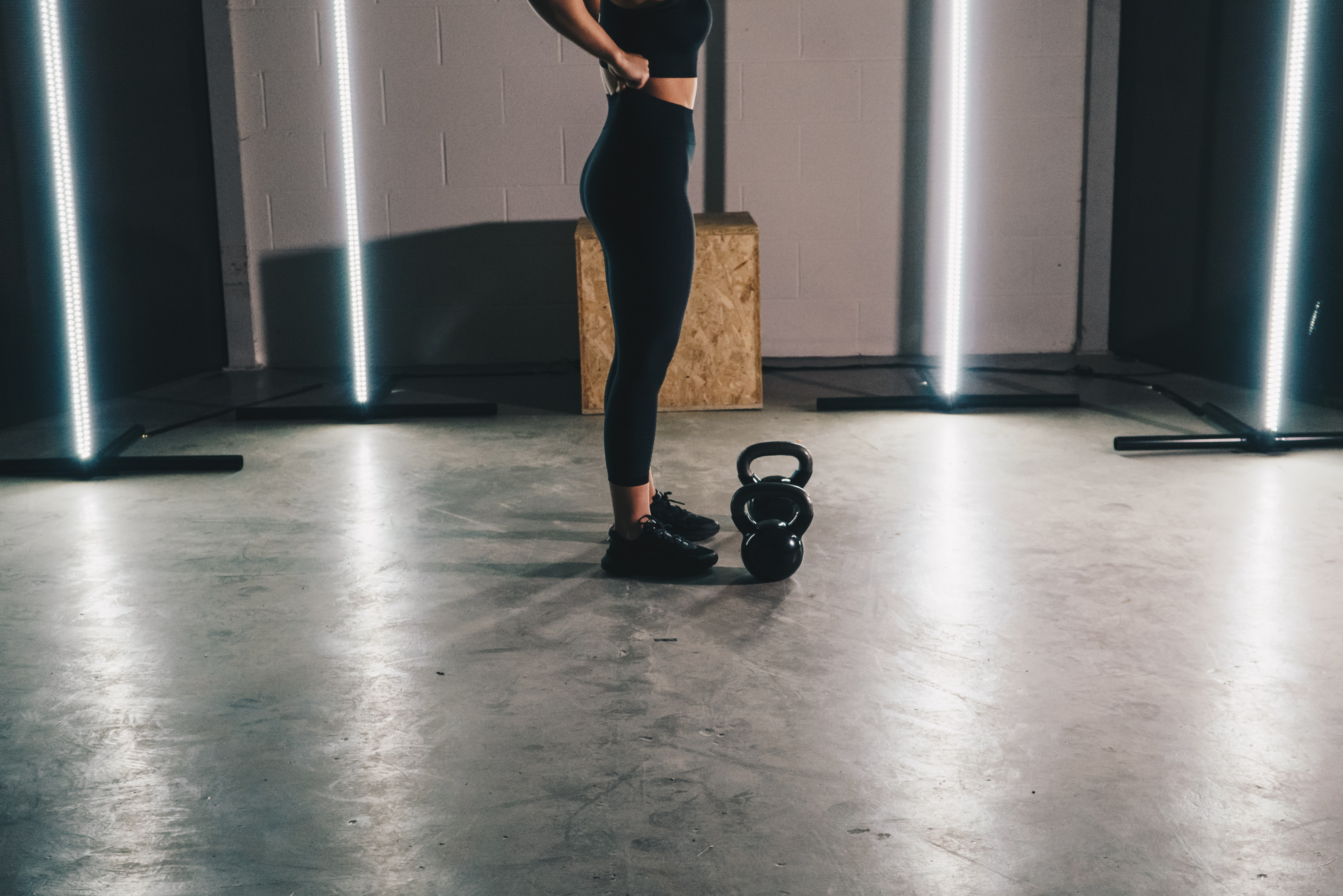 woman standing over a kettlebell between sets