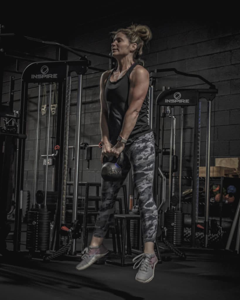 Danielle doing repeated kettlebell jumps at Beyond Strength in Sterling, Virginia