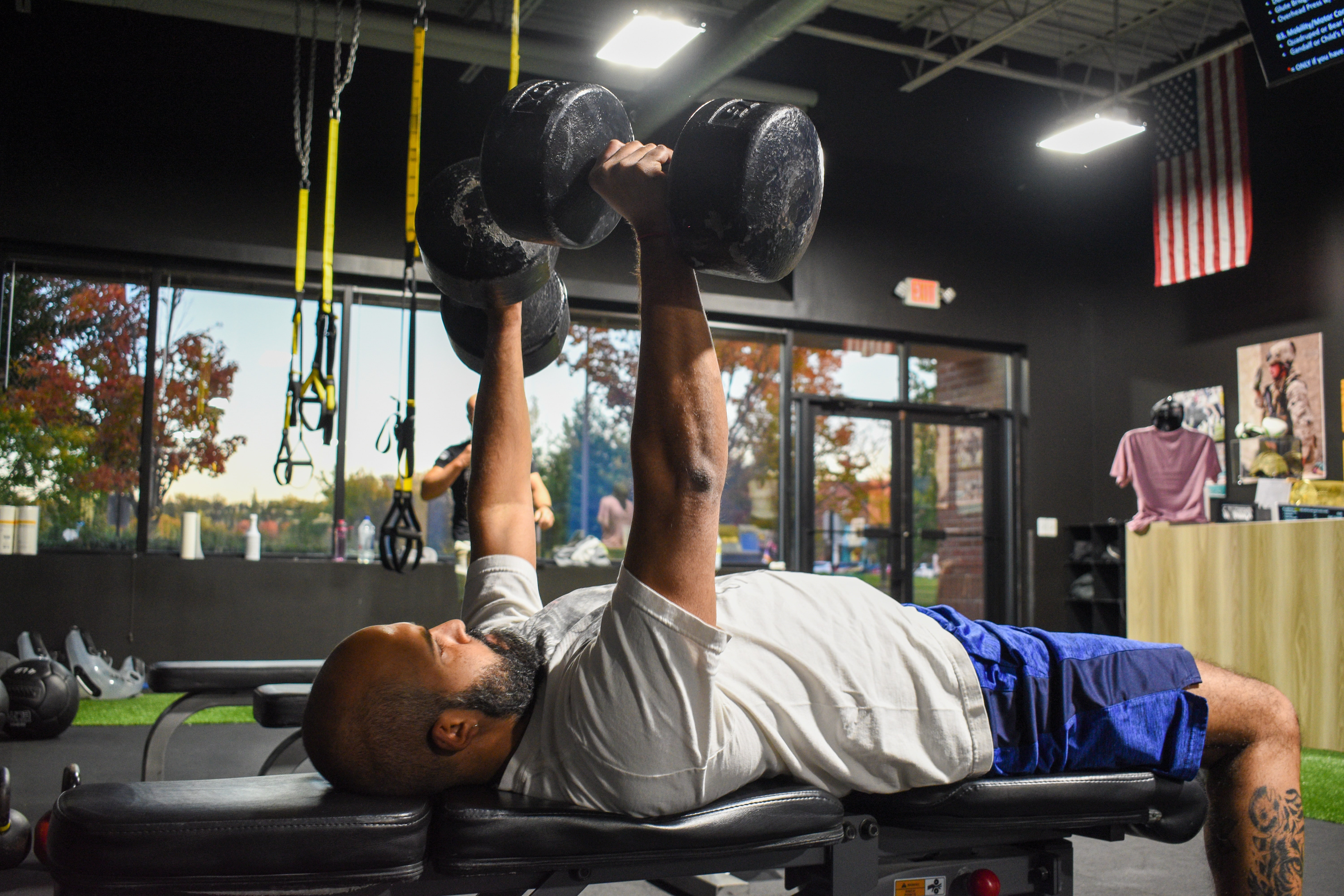Merson performing a dumbbell bench press at Beyond Strength in Sterling, Virginia