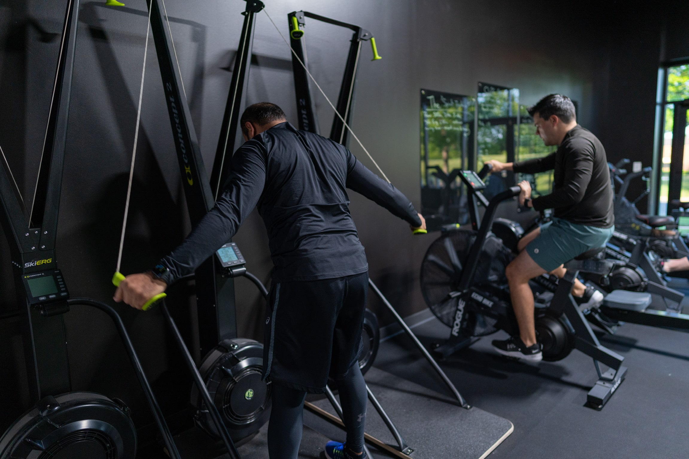 Anil and John ripping some cardio machines in a Vigor class at Beyond Strength