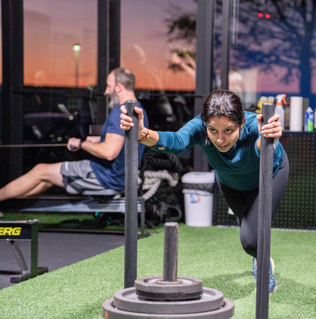 Jasmin pushing a sled during a Vigor class at Beyond Strength in Sterling, Virginia