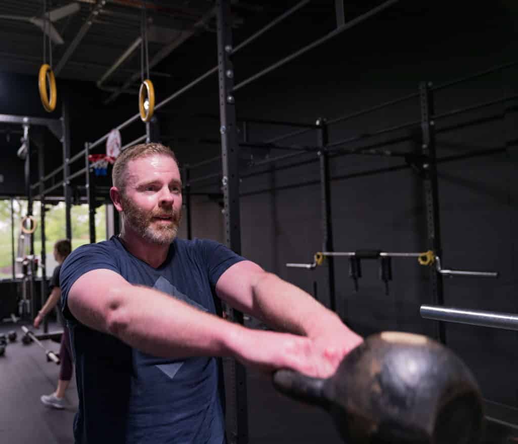 Brad swinging a kettlebell at Beyond Strength in Sterling, VA