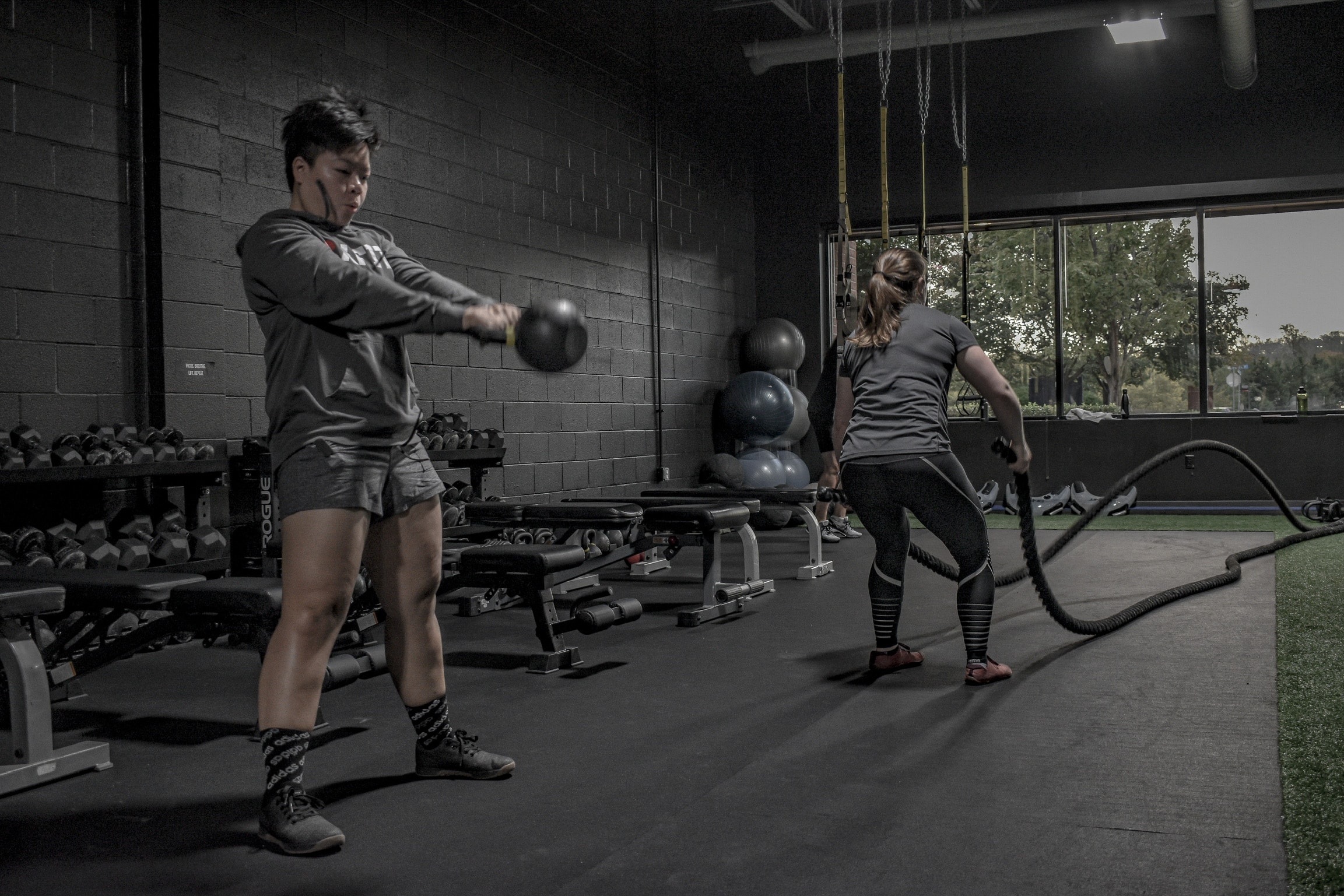 Sandy and Lauren training with kettlebells and batling ropes at Beyond Strength Strength in Sterling, Virginia