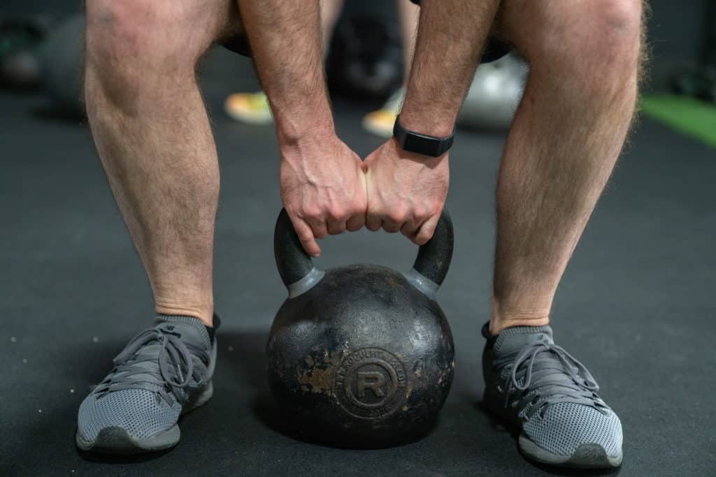 A member of Beyond Strength performing kettlebell deadlifts