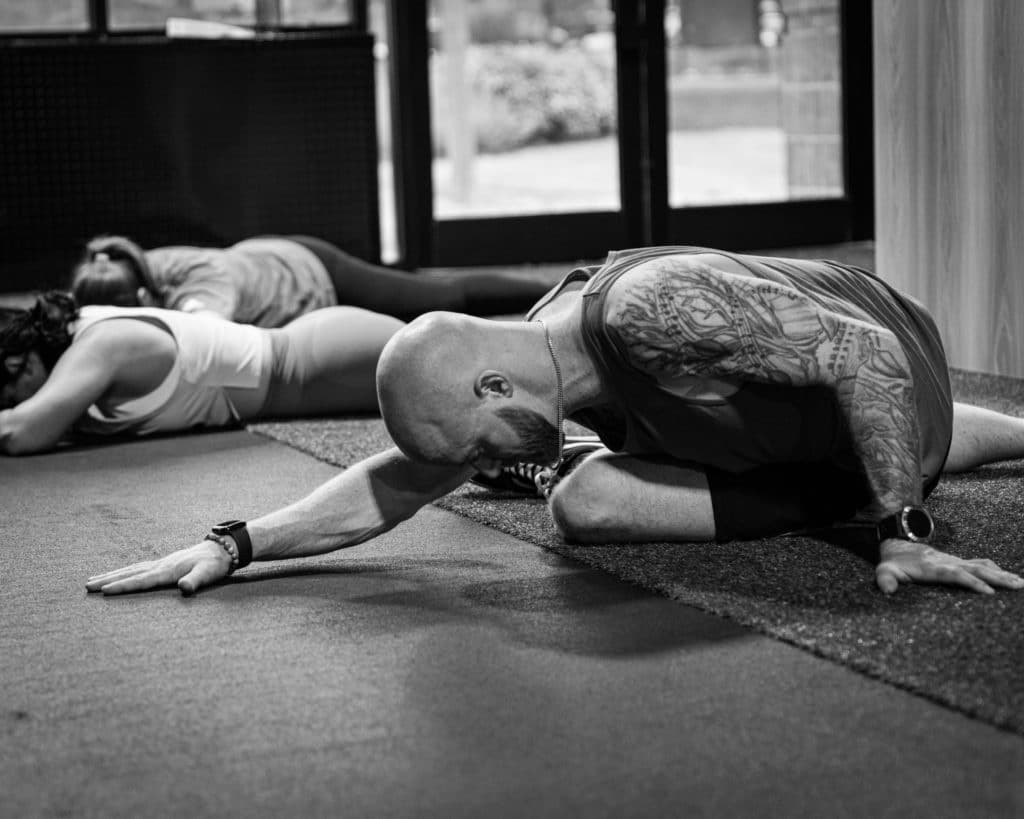 Members of Beyond Strength going through a cool down at the end of their workout