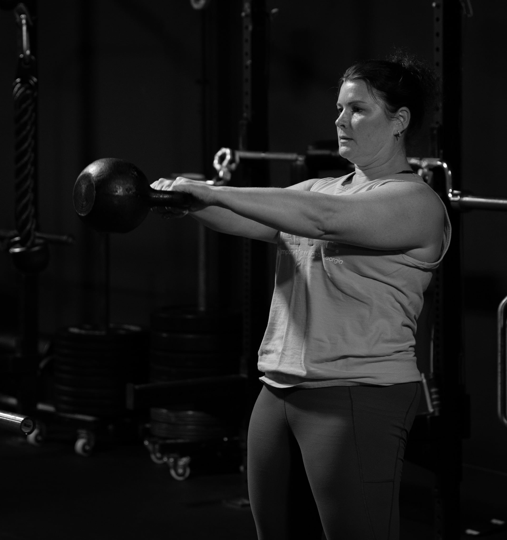 Michelle doing a kettlebell swing at Beyond Strength in Sterling, Virginia