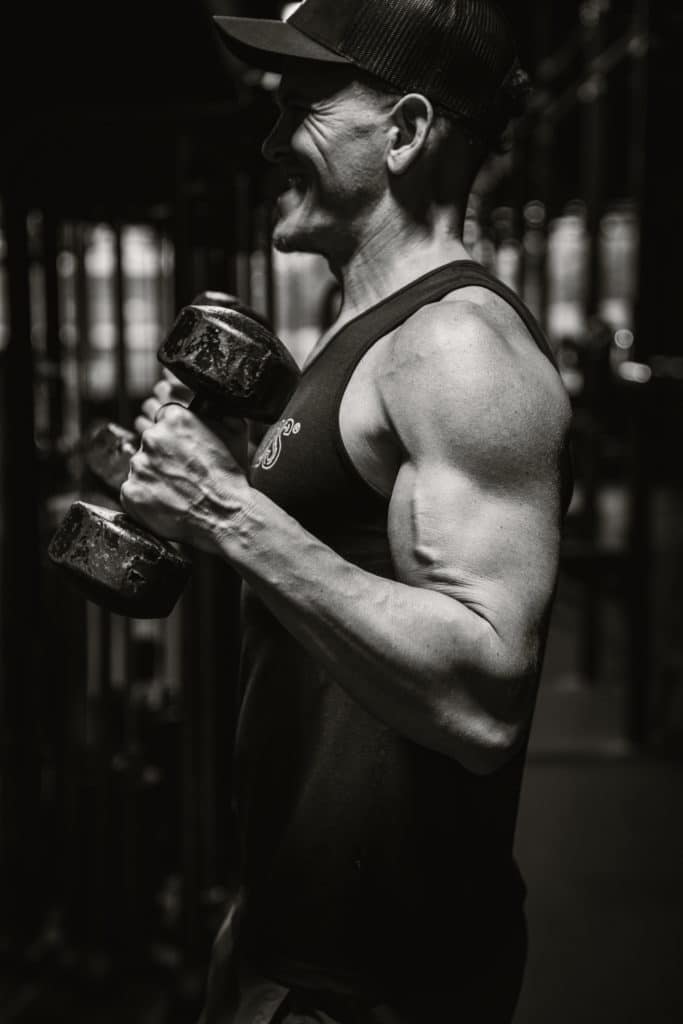 Coach Rony doing curls during a muscle growth phase of training at Beyond Strength gym in Sterling, VA