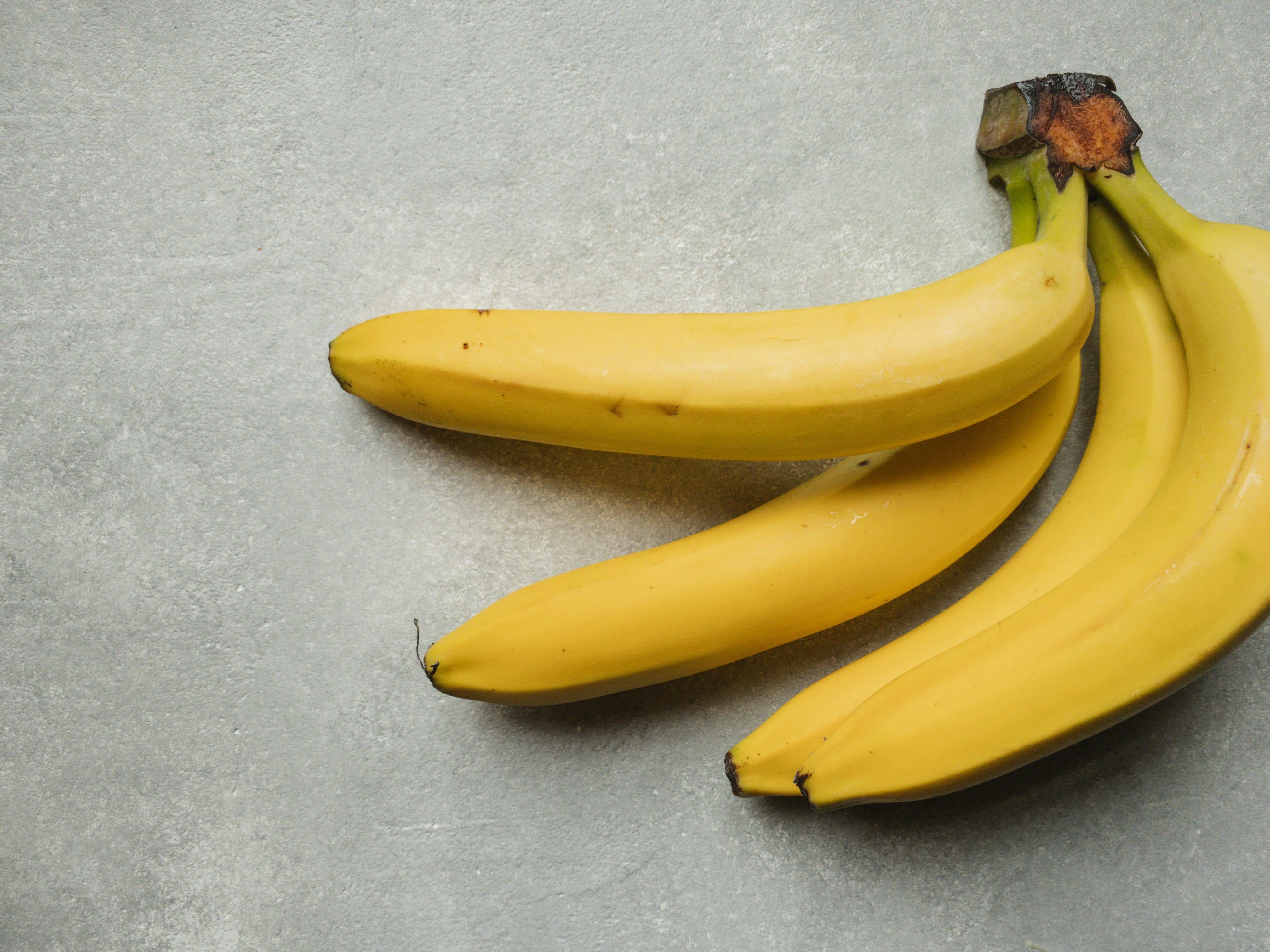 Fresh bananas on a kitchen counter, commonly used in healthy smoothies and snacks.